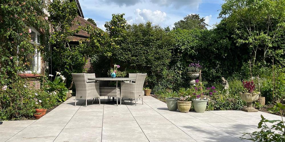 Chaos gardening trend with wild planting and a paved patio